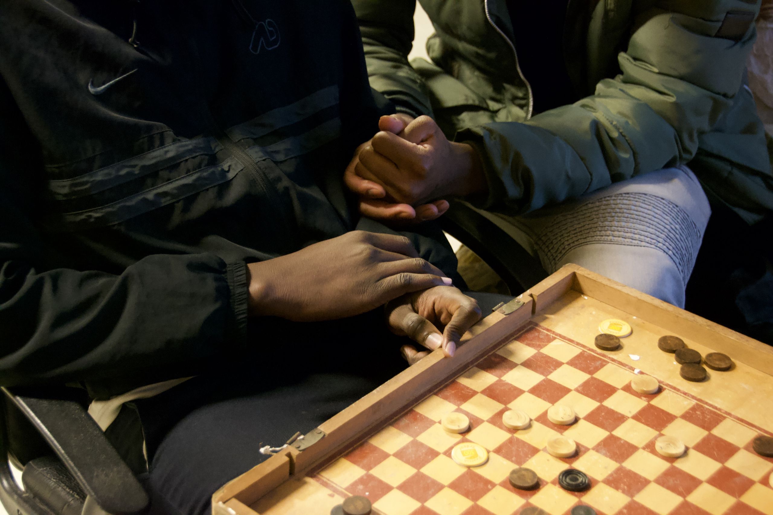 Les jeunes jouent aux dames pour contrer l'ennui et le froid.